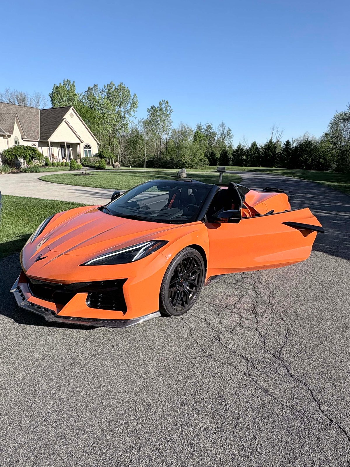 Orange C8 Chevrolet Corvette Z06 convertible with doors open